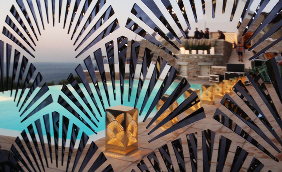 Poolside lighting in a Mykonos villa with gold mirror outdoor lamps